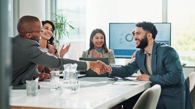 Businessmen, handshake or meeting with team applause for deal, agreement or success at office. Group, employees or colleagues shaking hands or clapping for business collaboration, winning or contract