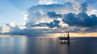 Offshore jack up rig in aerial view in the middle of the ocean taken by a drone