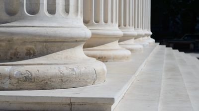 Row of stone columns with bases and steps in classical architectural style, showing texture, light, and shadow in detailed perspective.