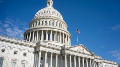 The United States Capitol Building against a clearing blue sky viewed from the east front of the U.S. Capitol building in Washington, DC.
