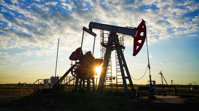 Una bomba de balancín en un pozo de un yacimiento petrolífero al atardecer en una zona de extracción de crudo. Bomba de balancín en funcionamiento en un yacimiento petrolífero. Bomba de balancín, plataforma de perforación petrolífera, torre de perforación en un yacimiento petrolífero. Gas natural, industria del petróleo crudo