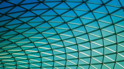 Glass panels forming geometrical shapes with a beautiful blue sky in the background