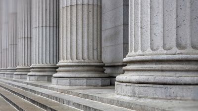 Stone colonnade and stairs detail. Classical pillars row in a building facade, New Yotk USA
