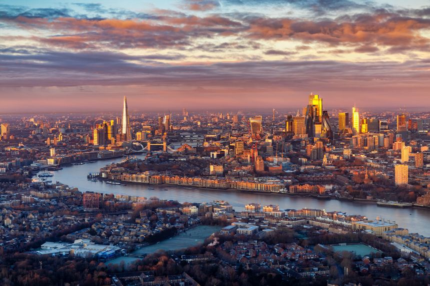 Panoramic view of the London skyline stretching from London Bridge until the office skyscrapers at the City during a colorful winter sunrise