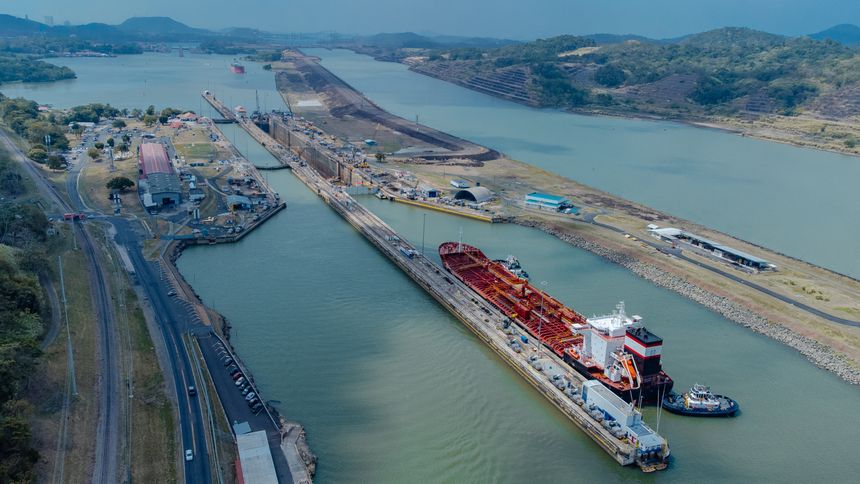 Panama channel, locks at Pedro Miguel and Miraflores in the background. Visible the city of panama behind. Panama channel is currently a question about trump and usa