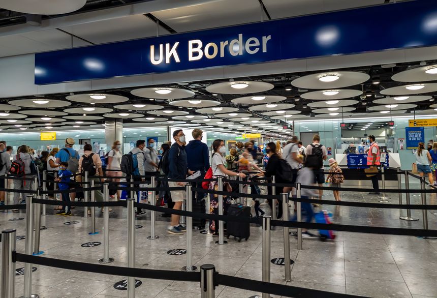 Heathrow Airport. UK- 08.08.2021: the UK Borders in Terminal 5 with arriving internation travel passengers waiting for immigration control and passport check.