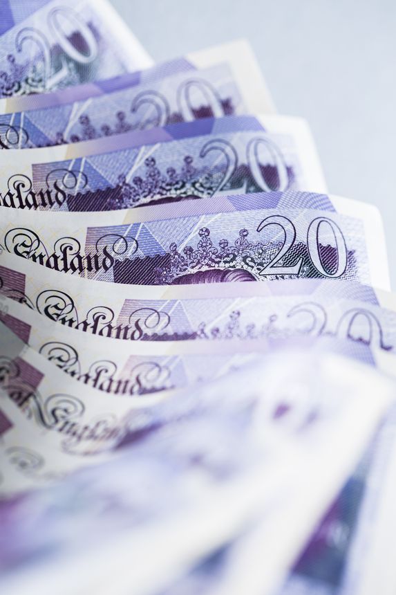 Close up of £20 notes Pound sterling on a simple background, no people.