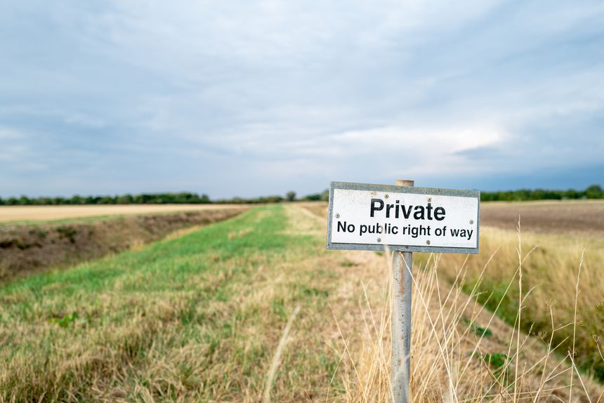 Shallow focus of a No Public Right of Way sign seen on farm land. Located near a public footpath, to help stop stray walkers accessing pricing farm land.