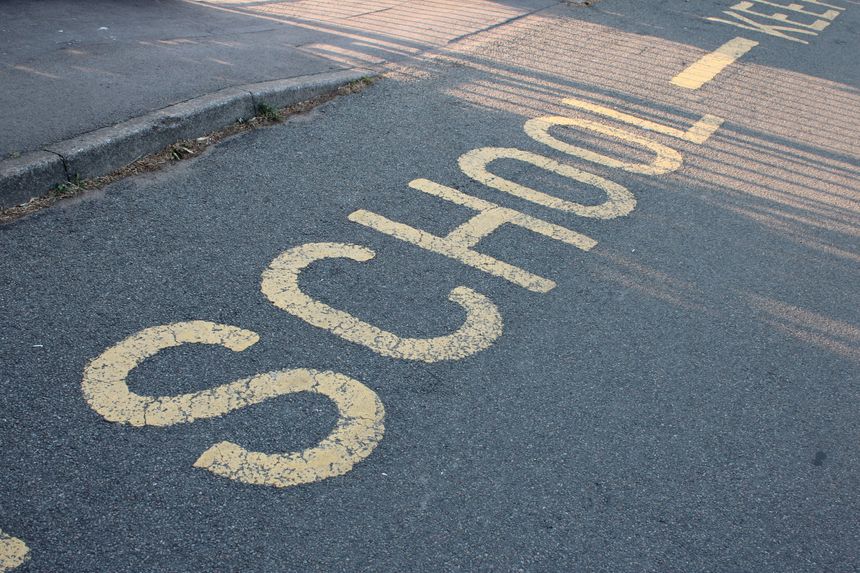 Yellow road marking "School" UK