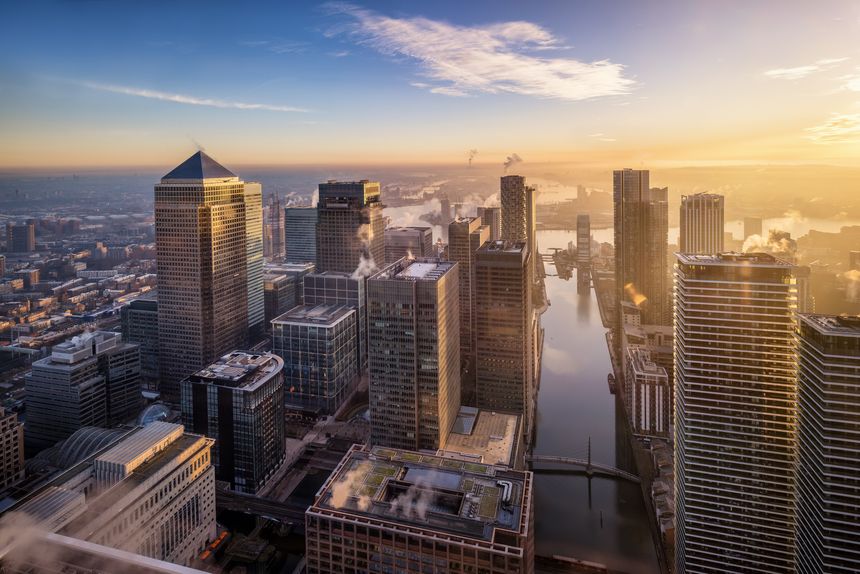 Panoramic sunrise view of the skyscrapers at the financial district Canary Wharf and the Docklands of London, England
