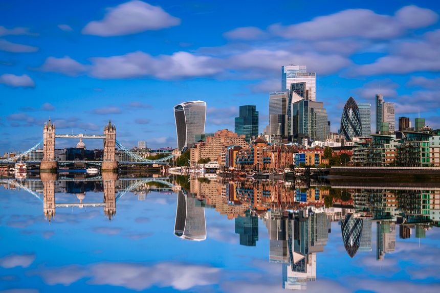 London City skyline reflected on the River Thames, a tranquil metropolitan beauty with modern high-rising architecture and Tower Bridge in the heart of the United Kingdom.