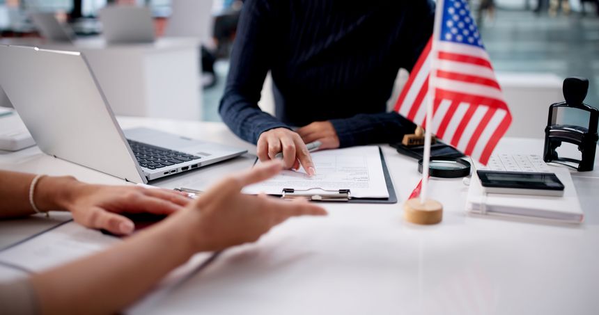 Young Latina Woman Reviews Her US Visa Application With Lawyer.