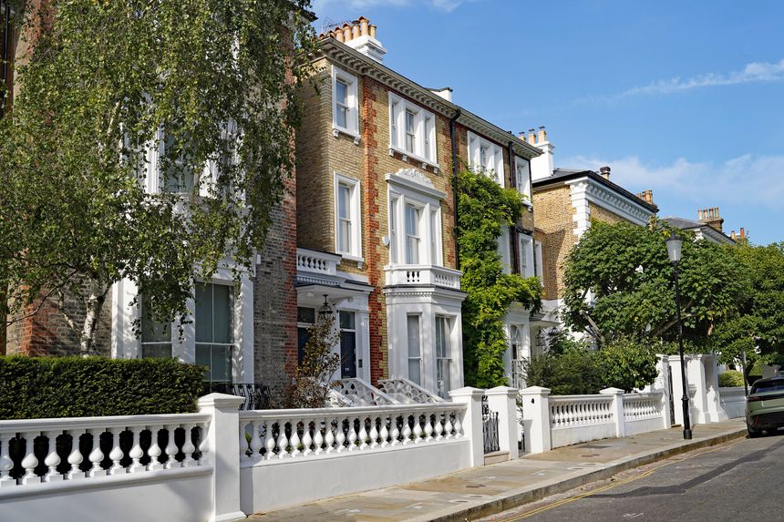 Elegant street of colorful old brick townhouses and apartment buildings in Chelsea district of London