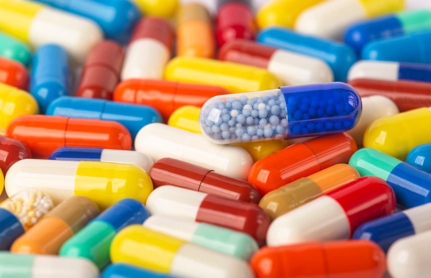 many colored pills close-up red, blue, yellow