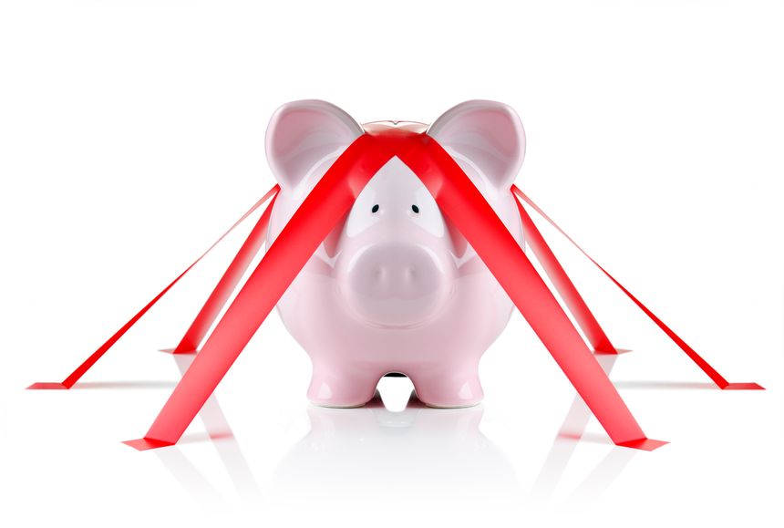 Piggy bank wrapped with red tape