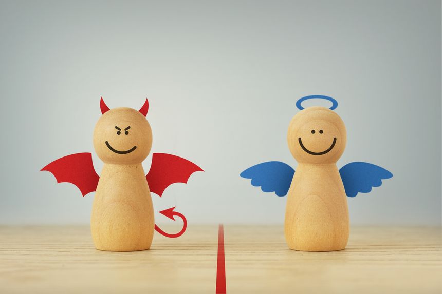 Devil and angel wooden pawn - Good and evil concept