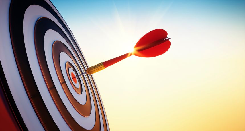 Close up shot of red dart arrow hitting on bullseye of dartboard in bright sunlight - 3D illustration