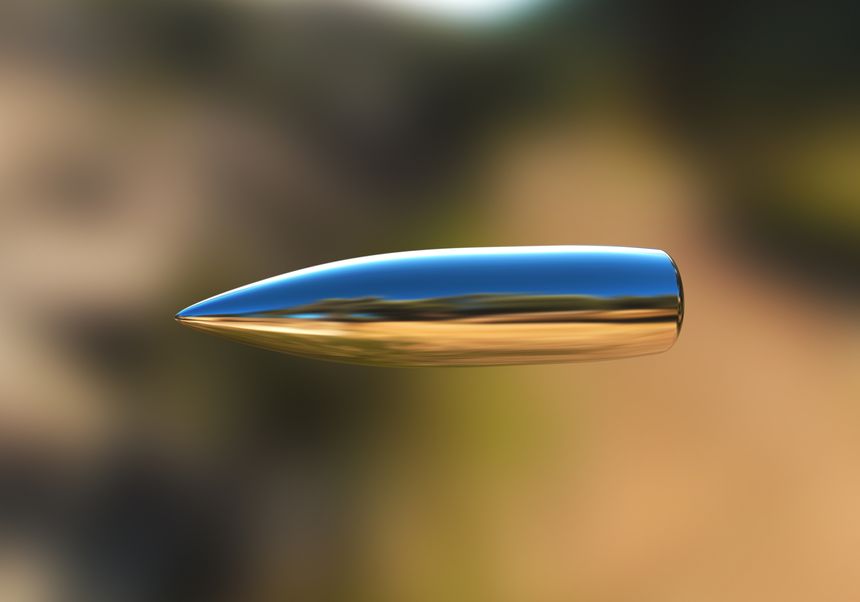 Macro shot of silver bullet caught in flight. See also: