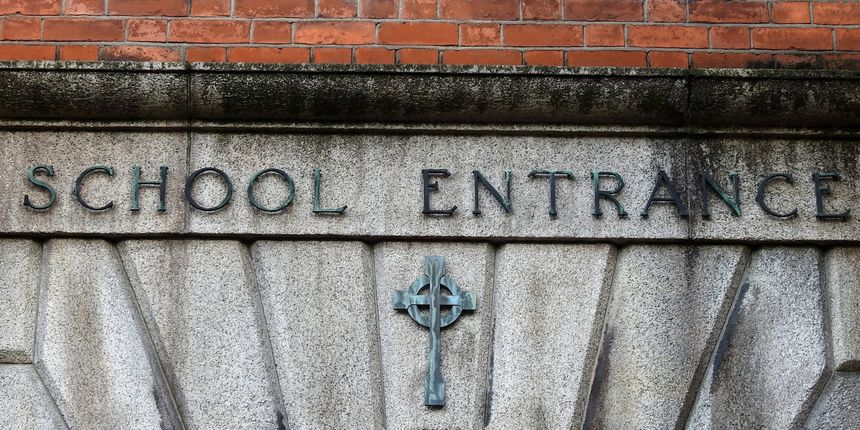 School Entrance sign above Celtic cross.