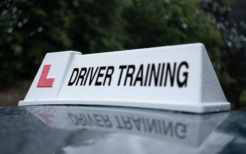 A Driver Training Sign On The Top Of A Car In The UK