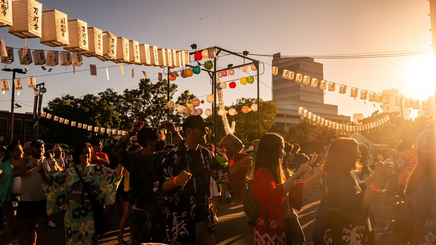 People dancing Bon Odori at Higashi Obon Festival, Japanese Obon Festival Event at Higashi Honganji Buddhist Temple in Little Tokyo, Los Angeles, California. Obon is a traditional Japanese event honoring ancestral spirits.