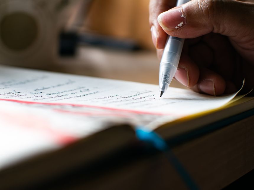 Close-up Hand Writing Notes with Pen in Notebook - Student Study Session and Academic Learning Process.