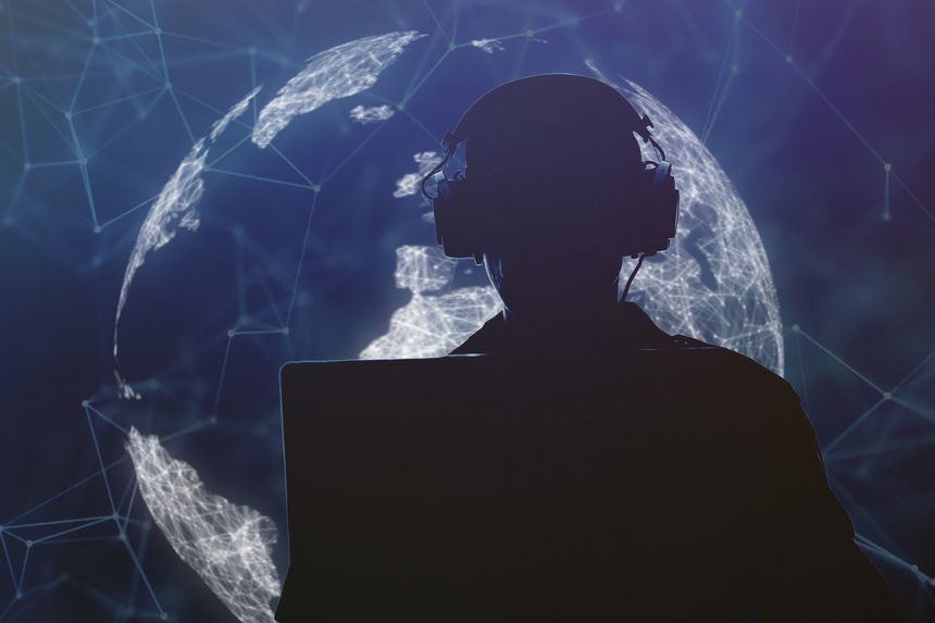The silhouette of a military man in headphones at a laptop against a glowing background of a tangle of lines and dots, contour lighting. Concept: information gathering, surveillance and control.