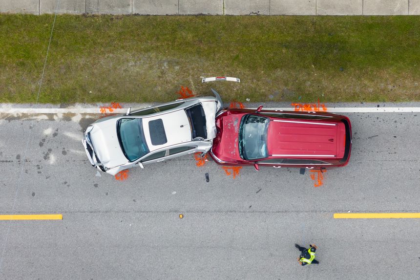 Car crash with two vehicles collided at traffic accident site on American street.