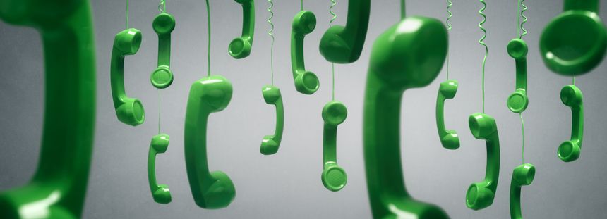 Green telephone receivers hanging over gray background concept for on the phone, customer service, on hold or contact us