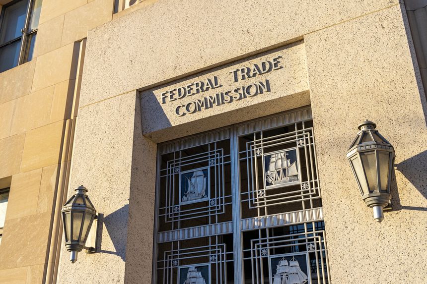 Exterior of the Federal Trade Commission (FTC) building in Washington, D.C., with a door under the sign depicting sailing ships.