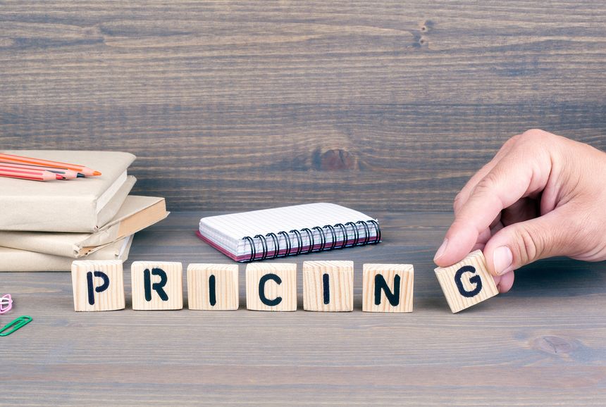 pricing concept.Wooden letters on dark background. Office desk