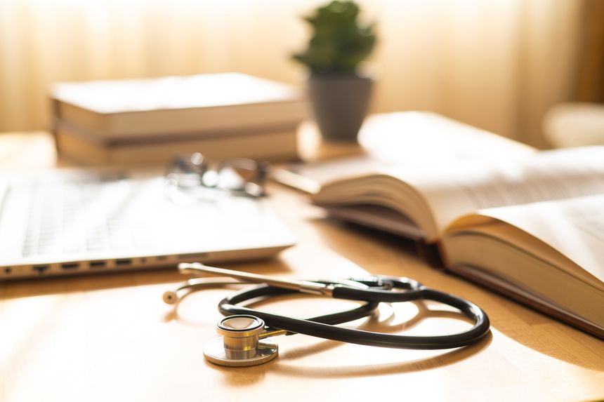Hospital Work Environment Featuring Medical Notepad And Stethoscope, Reflecting Professional Patient Care And Dedication