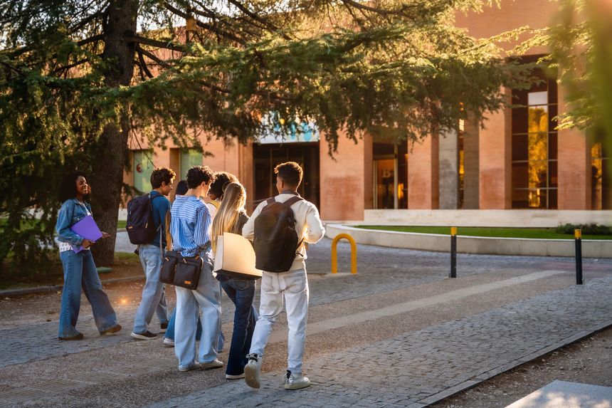 Group of young and mid-adult students from diverse backgrounds walking together on a university campus, representing education, friendship, and new learning opportunities