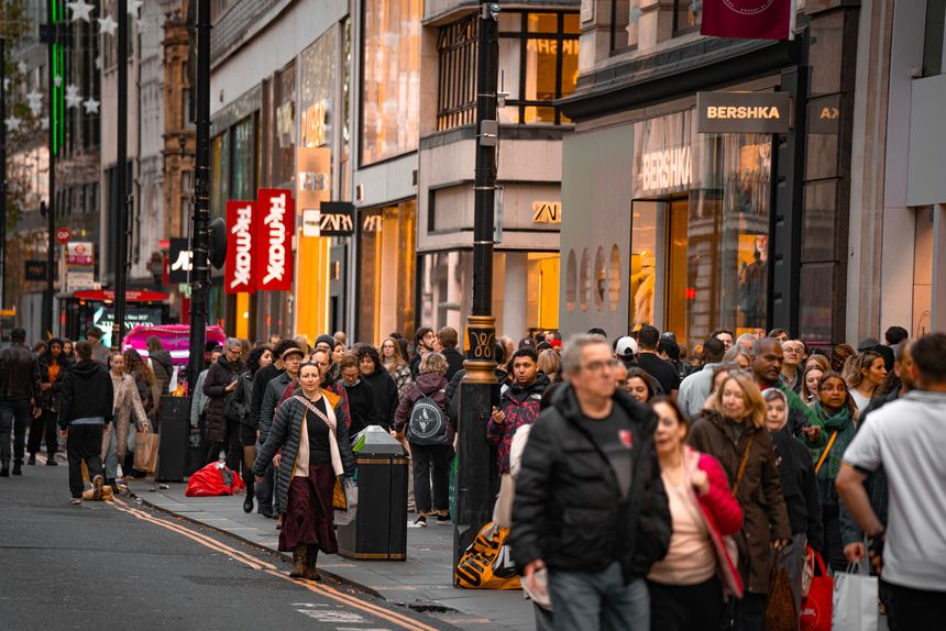 London, UK – 1 November 2025: Pedestrians weave past the façades of TK Maxx and Bershka on Oxford Street in central London during the festive Christmas season. Crowded Oxford Street Christmas season pedestrians, TK Maxx and Bershka storefronts.