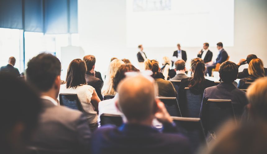 Interview and round table discussion at business convention and presentation. Audience at the conference hall. Business and entrepreneurship symposium.
