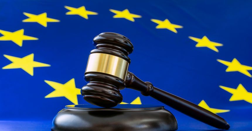 Closeup of judge gavel and european flag in the background. Human rights in the Court of Justice of the European Union, ECJ.