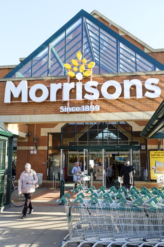 London, UK - February 25, 2019. Shoppers outside the front of a Morrisons supermarket in Hatch End, London. WM Morrison is the UK's fourth largest chain of supermarkets