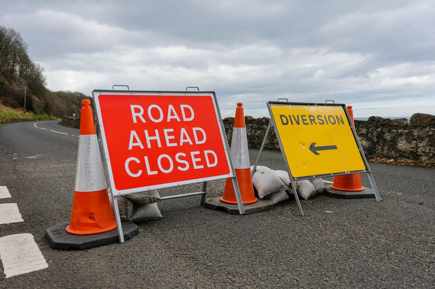Road Closed and diversion signs on a coastal road