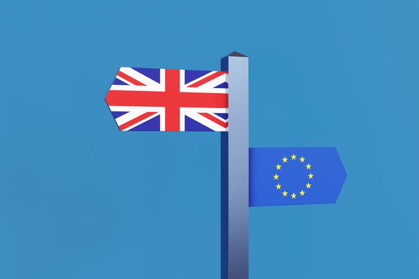 Directional signs showing the national flags of the UK and EU on a finger post in blue sky. Illustration of the concept of Brexit