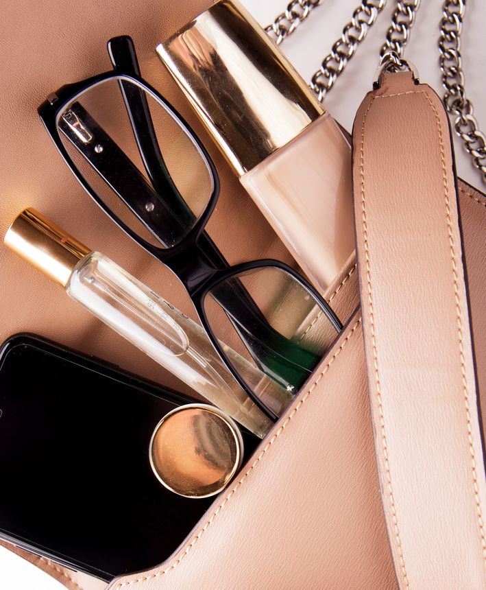 Flat lay of female fashion accessories and pink handbag on white background with copyspace. Beauty concept. Close up.
