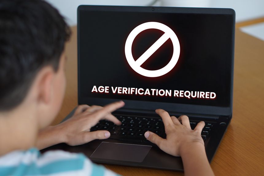 Age Verification Moment. Teenager looking at laptop screen with message Age verification required