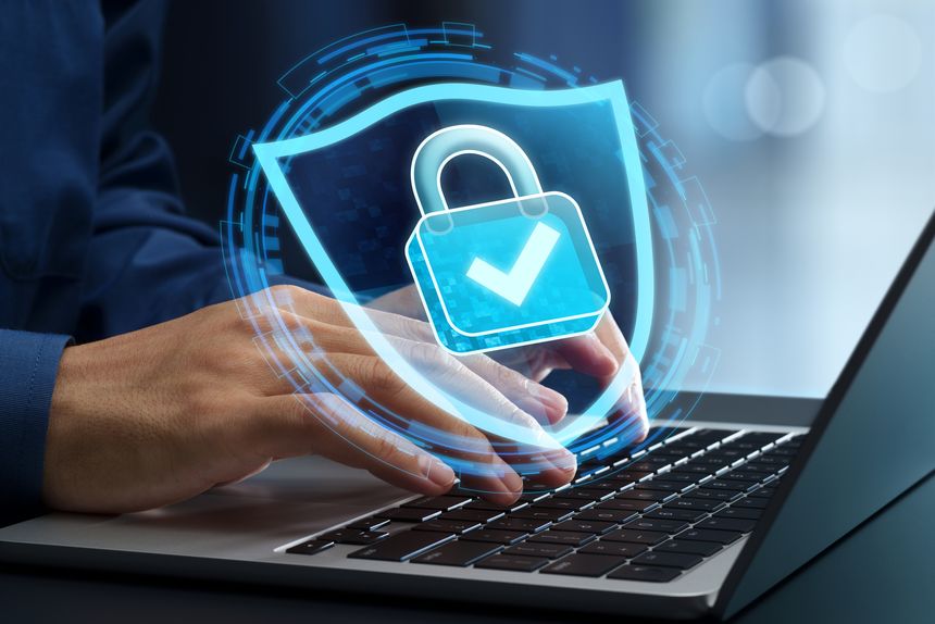 Businessperson using laptop computer with an encrypted connection in network system.