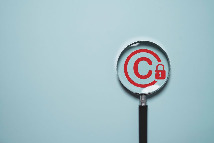 Copyright protection concept with copyright symbol and security lock in magnifier glass for creative thinking idea intellectual property rights protection, licensing law and digital patent ownership.