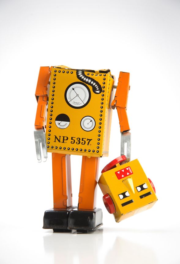 Broken toy robot on white cyclorama