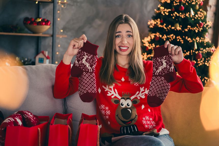 Photo of lovely cheerful girl dislike socks shopping dressed red christmas garment tradition atmosphere decor vibe house indoors room.