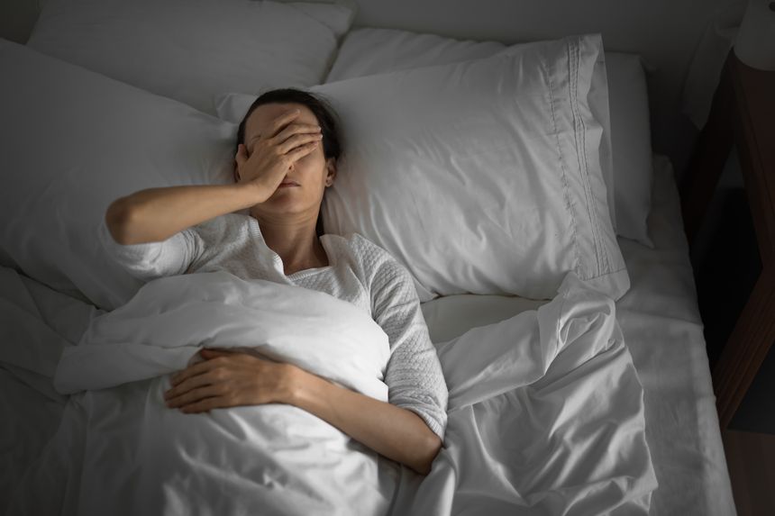 Woman feeling sick and tired in the bed.