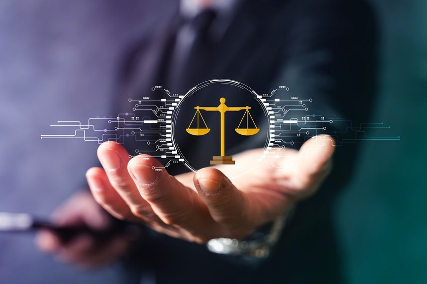 Businessman holding virtual scales of justice with digital circuit interface, representing legal technology, cybersecurity compliance, online law services, and regulatory protection.