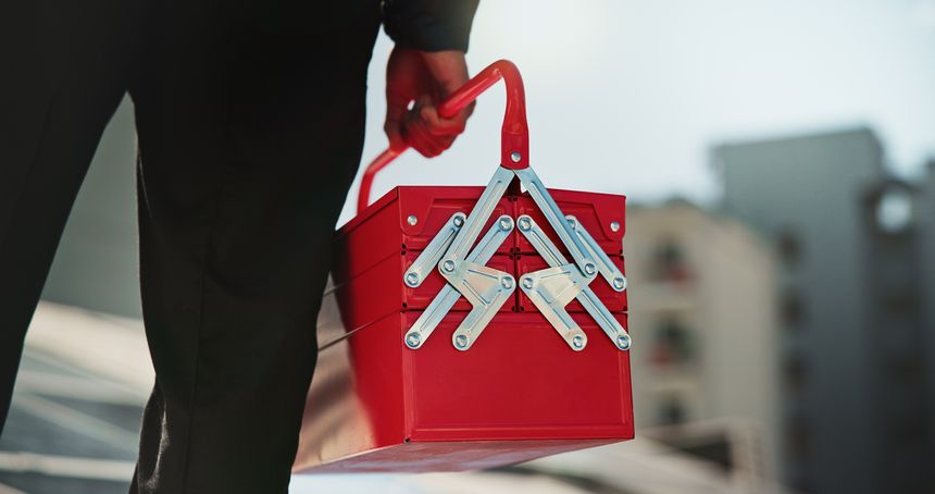 Hands, toolbox and repair with person on roof for solar panel maintenance, check or inspection in city. Engineer, technician and outdoor with gear for renewable energy with sustainability