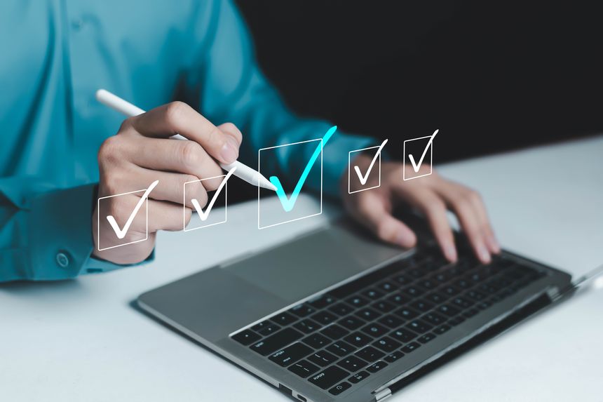 Professional working on laptop using digital pen to complete virtual and business checklist. Concept of task management, online approval, digital workflow, productivity, quality control, remote work,