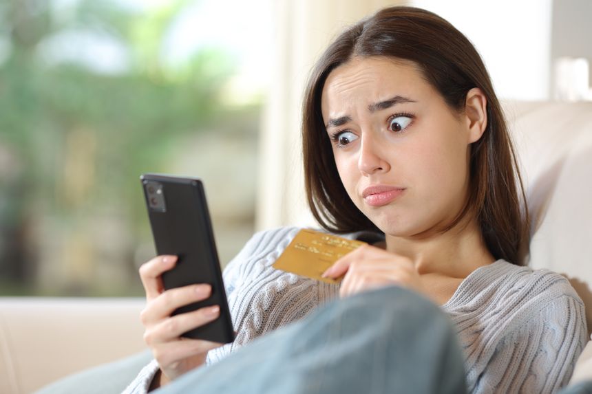 Confused woman buying online at home